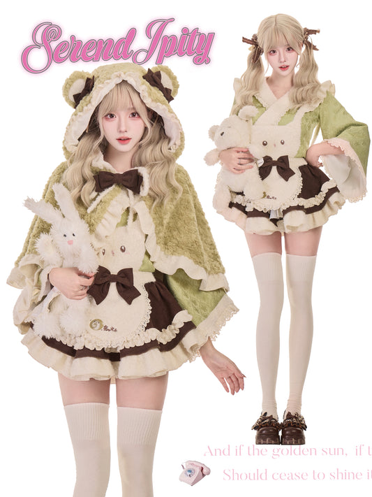 Two people wearing matching outfits with animal-themed elements, holding plush toys, and posing against a white background.