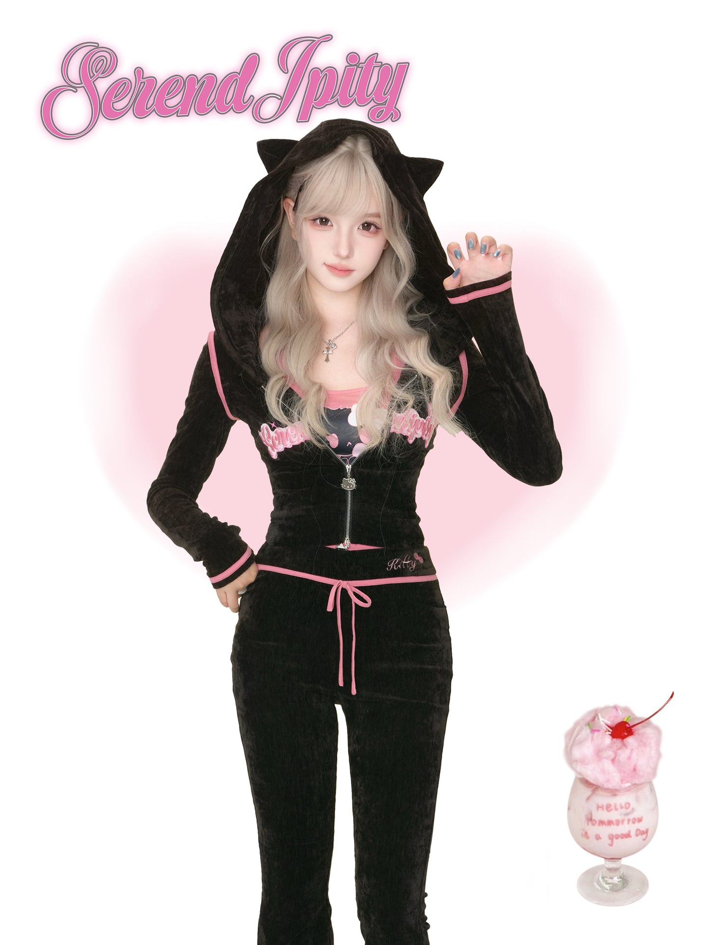 Person wearing a black cat-themed hoodie with pink accents, standing against a white background with 'Serendipity' text.
