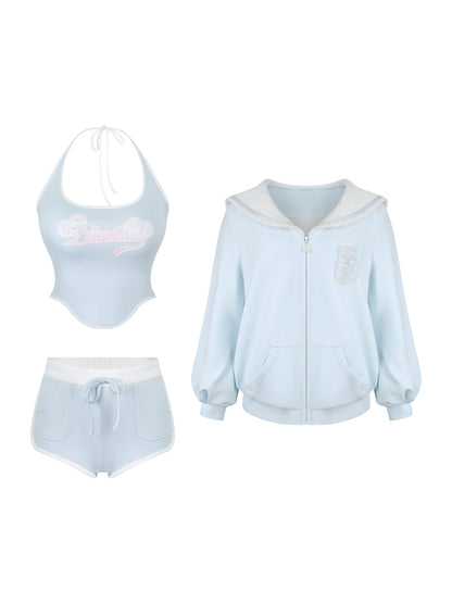 Three piece of light blue tracksuit, halter neck tank top, and track shorts on a white background.