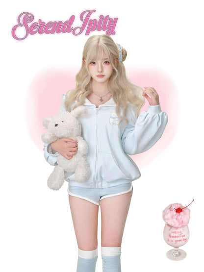 A person wearing a cute light blue tracksuit.