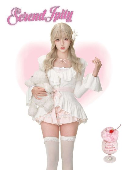 Person in a white outfit with fluffy sleeves and a pink cherry dessert on a white background