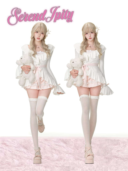 Two women in matching outfits holding teddy bears on a white background