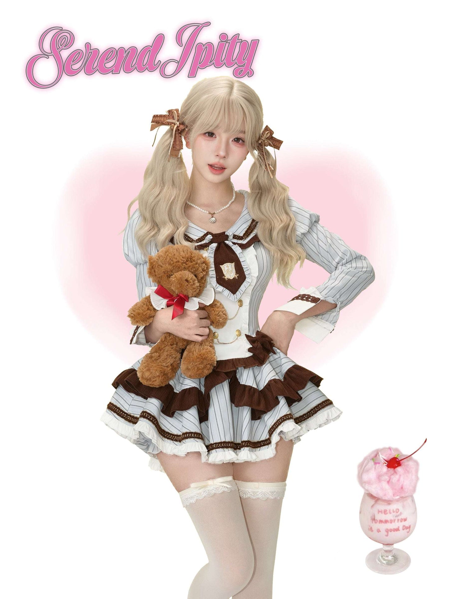 Person in a blue and brown outfit holding a teddy bear