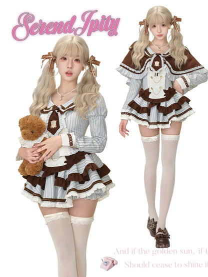 Two women in a coordinated outfit, holding a teddy bear.