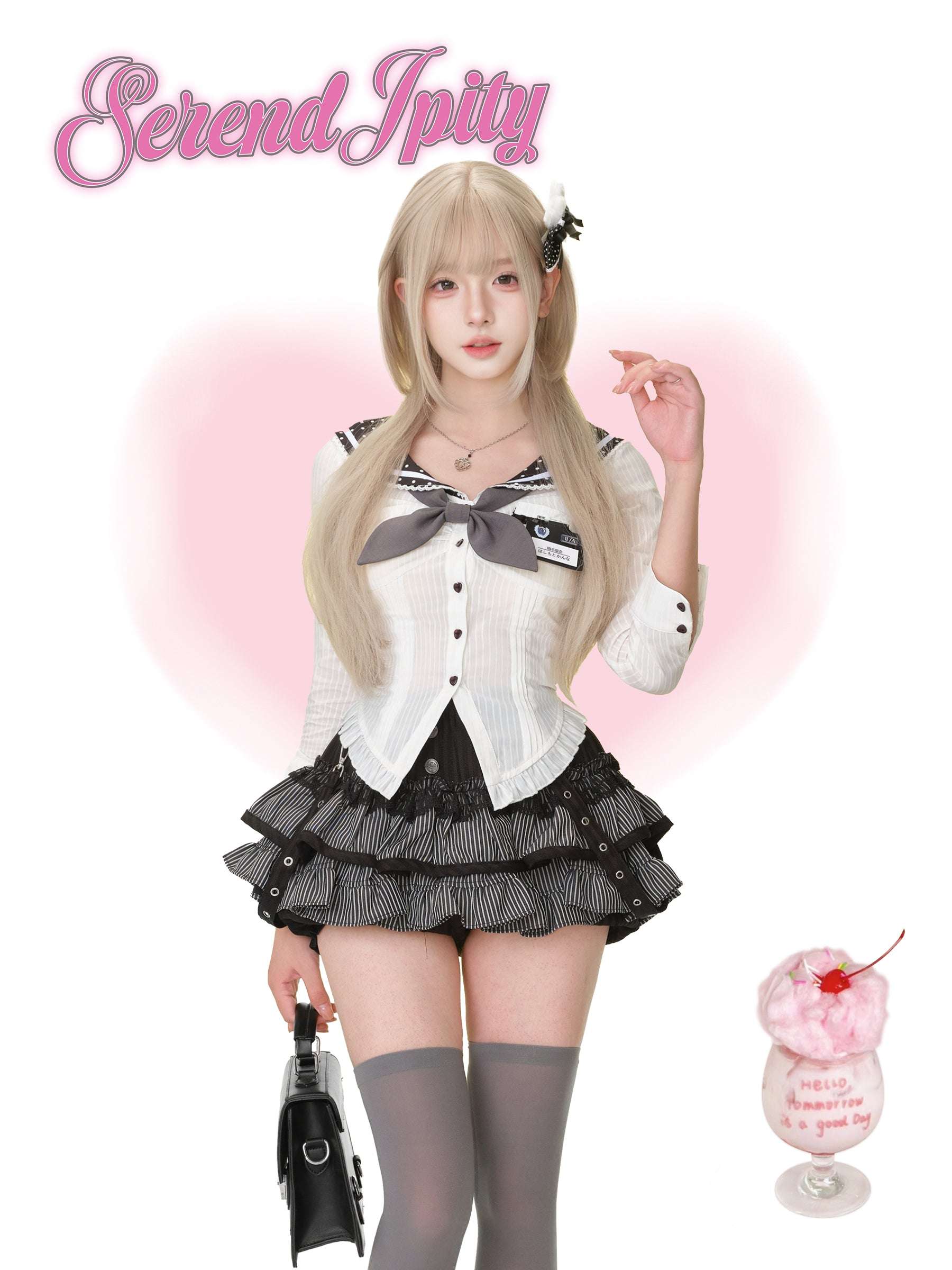 Person wearing a black and white outfit with a bow tie, holding a drink with a cherry on top.