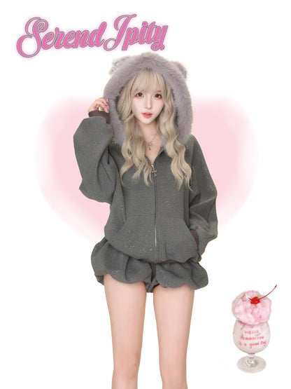 Person wearing a gray hoodie and shorts set with fluffy hood, standing against a white background with 'Serendipity' branding.