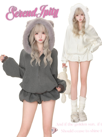 Two people wearing fluffy hoodies with the brand 'Serendipity' displayed.