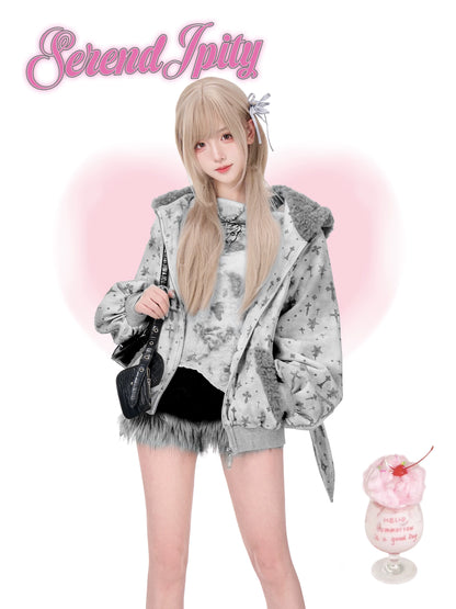 Person wearing a gray hoodie with fluffy trim, holding a black bag, on a white background