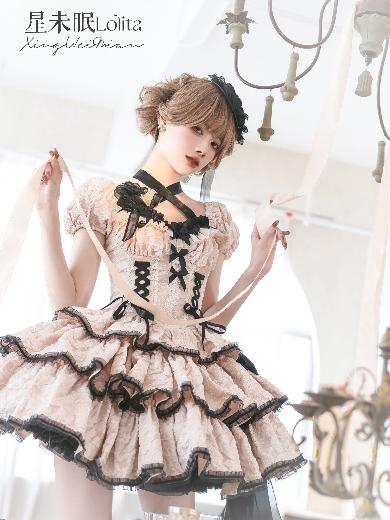 Person wearing a detailed dress with black lace trim in an elegant interior setting.