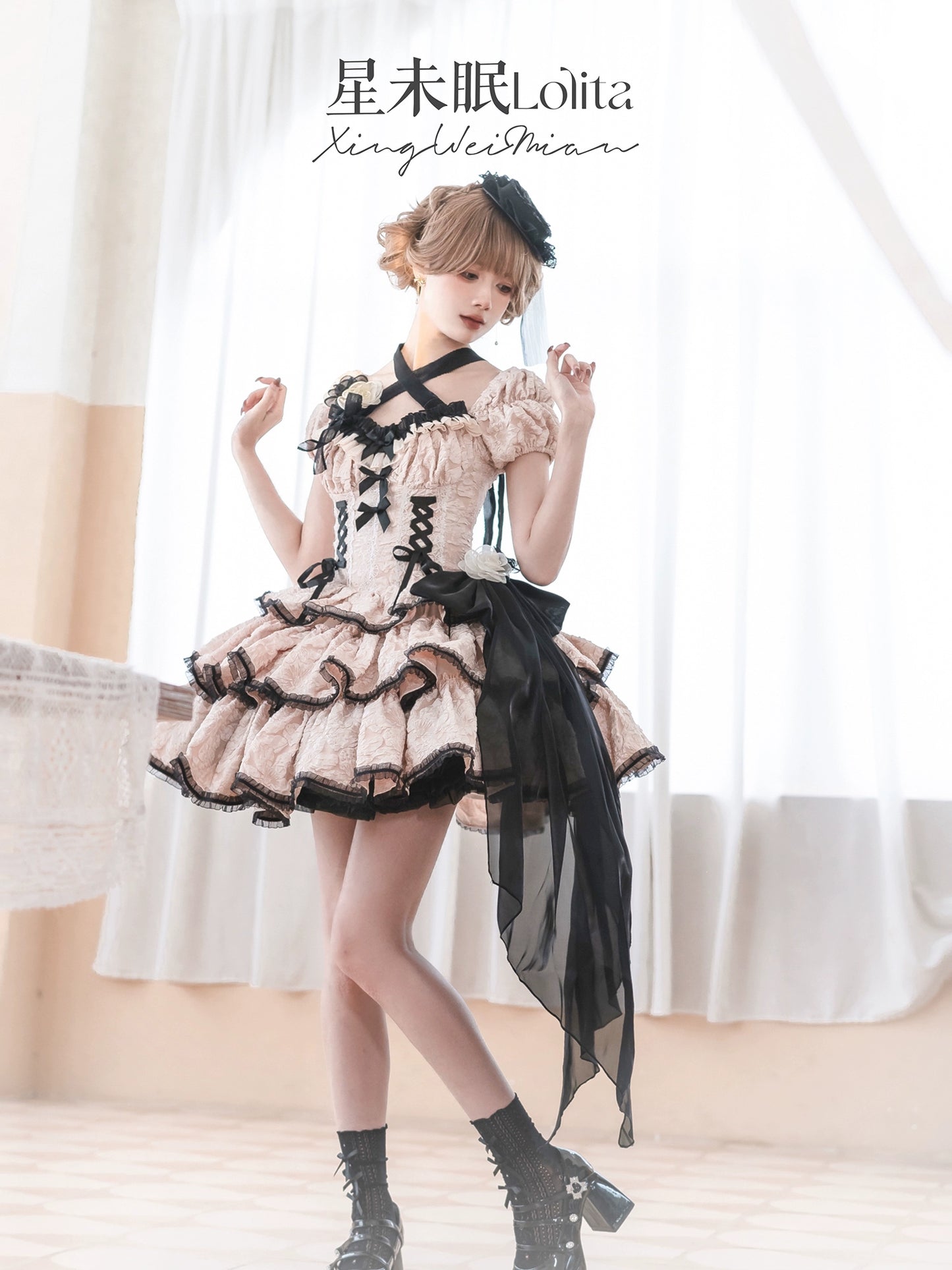 Person wearing a Lolita fashion outfit with black and white details in a softly lit room.