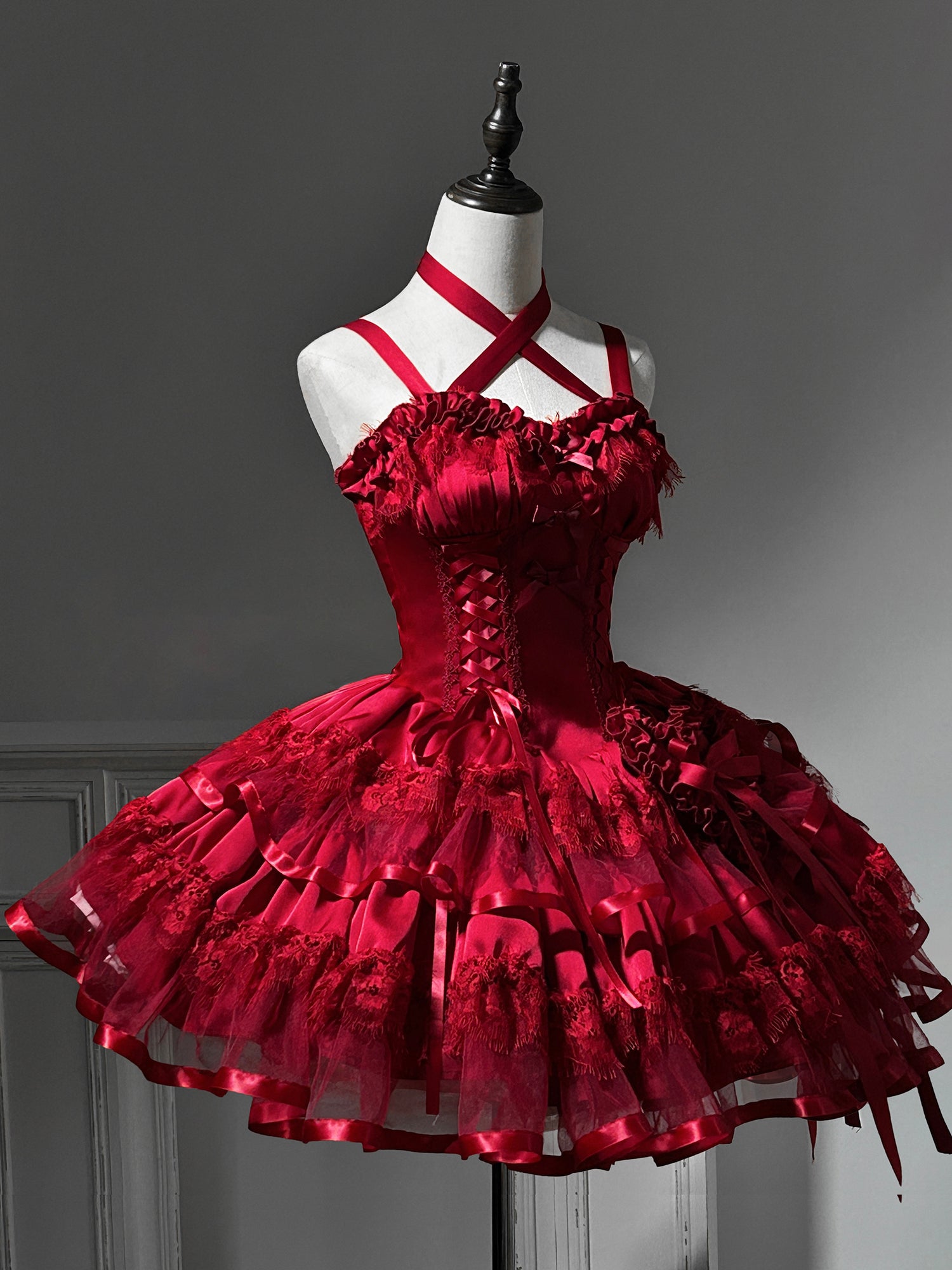 Red gothic-style dress on a mannequin against a gray background