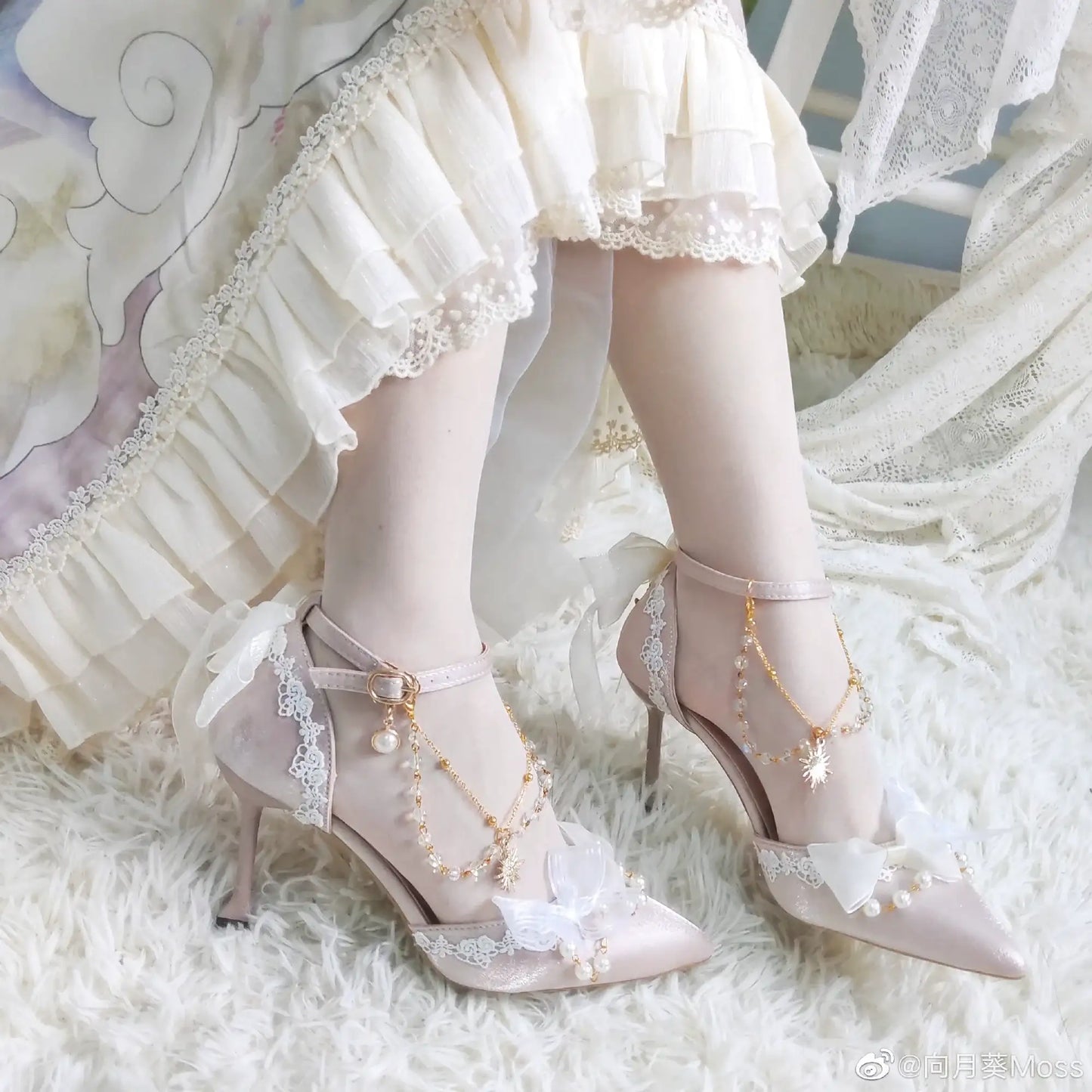 Delicate high-heeled shoes with lace and pearl details on a soft white background