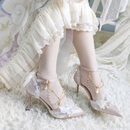 Delicate high-heeled shoes with lace and pearl details on a soft white background