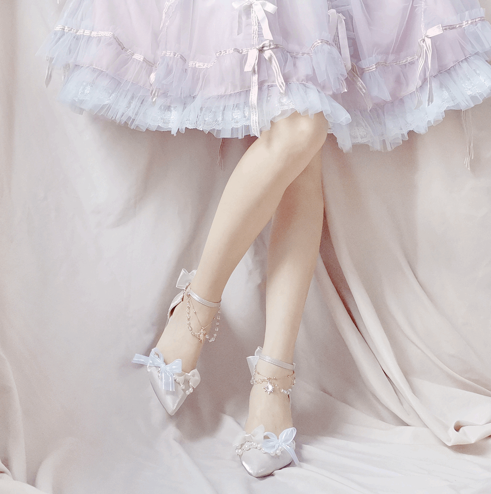 Pastel-colored dress with ruffled layers and white shoes with bows on a light background