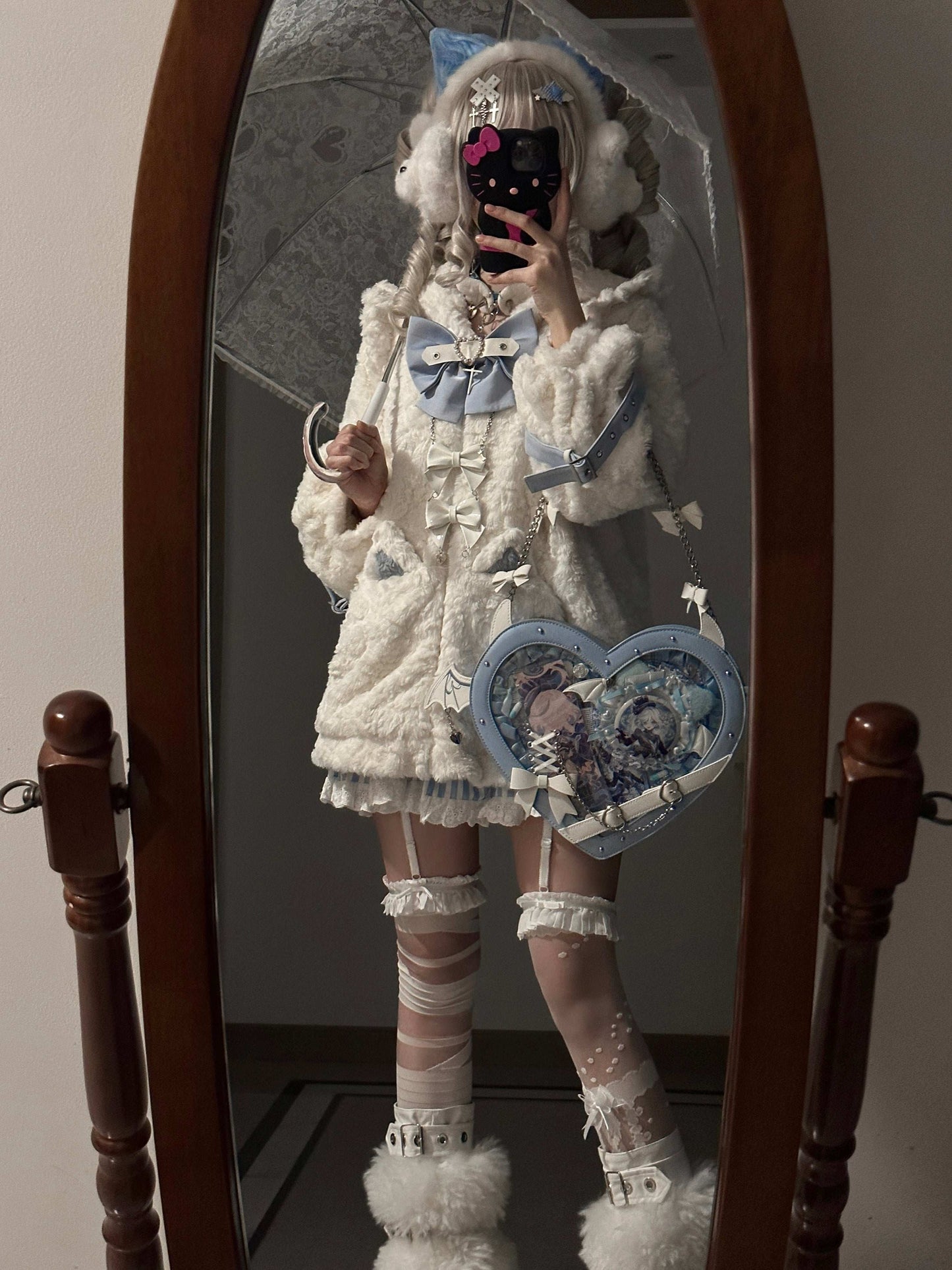 Person in a white outfit with decorative elements standing in front of a mirror.