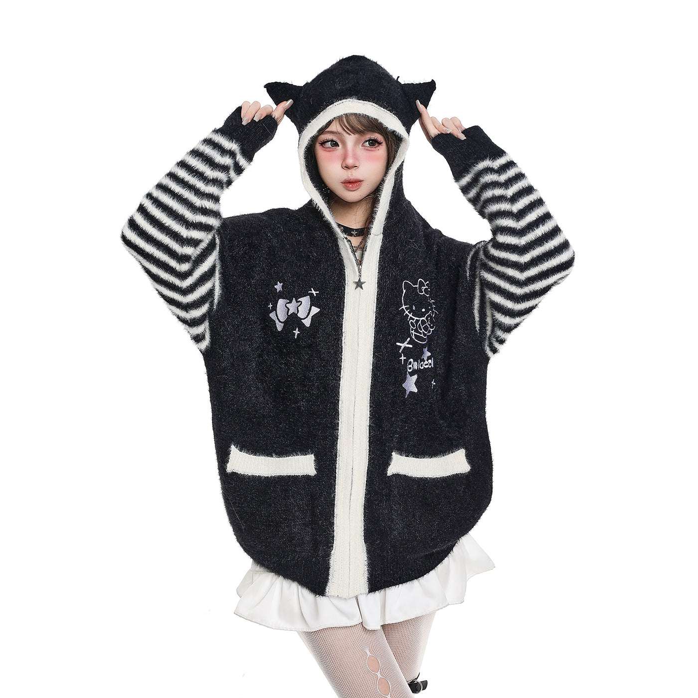 Person wearing a black and white striped hoodie with cartoon designs on a white background