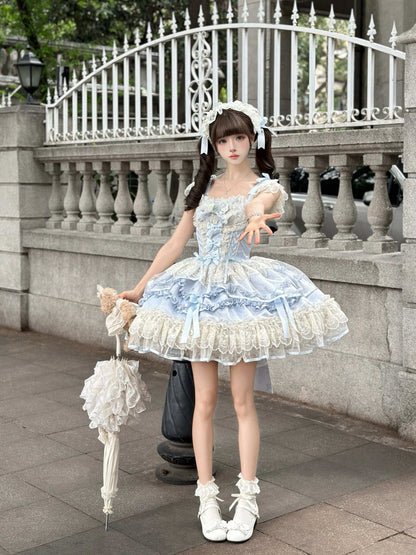 Woman in a light blue and white dress standing outdoors with decorative elements.