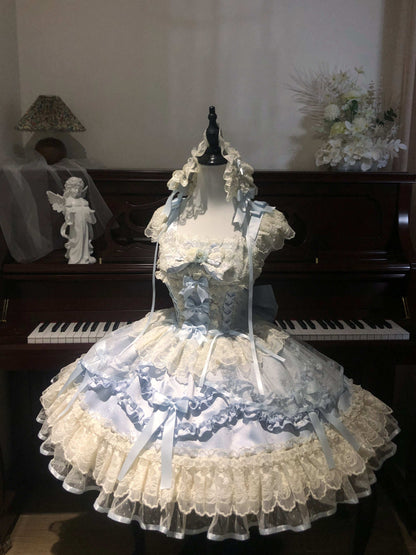 Blue Lace dress on a mannequin in front of a piano