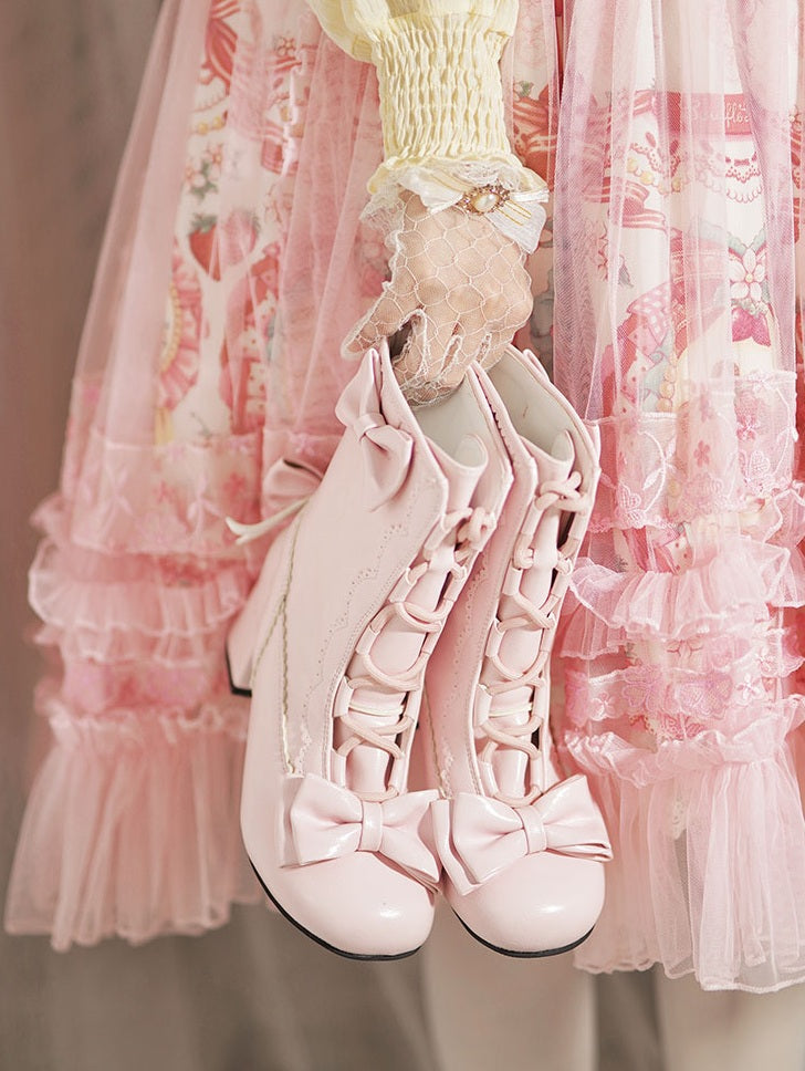 Pink high-heeled shoes with bows in front of a pink ruffled curtain