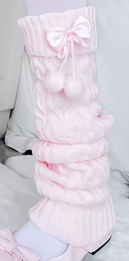 Pink knitted leg warmers with a bow on a white background