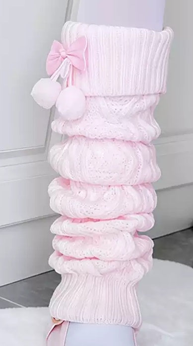 Pink knitted leg warmers with a bow on a white background