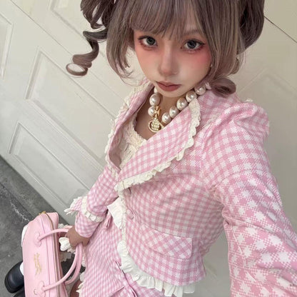 Person wearing a pink checkered outfit with ruffles and holding a pink bag.