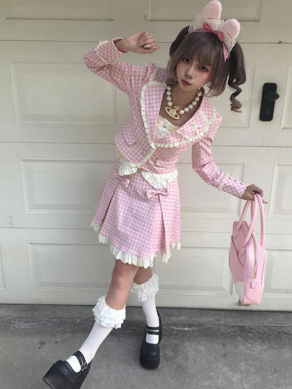 Person in a pink checkered outfit with a headband and white shoes, standing in front of a white door.