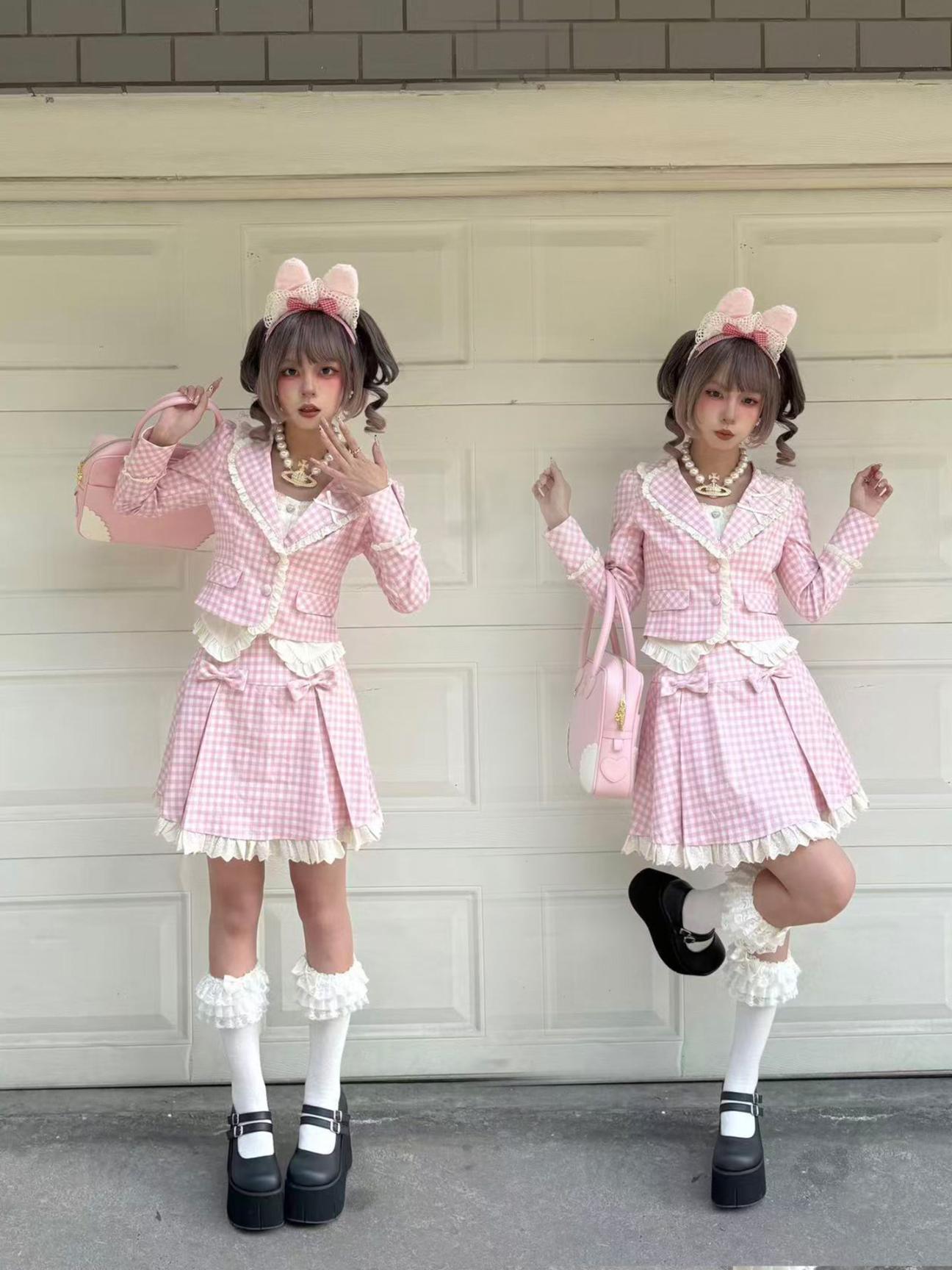 Two people in matching pink checkered outfits with bunny ears standing in front of a garage door.