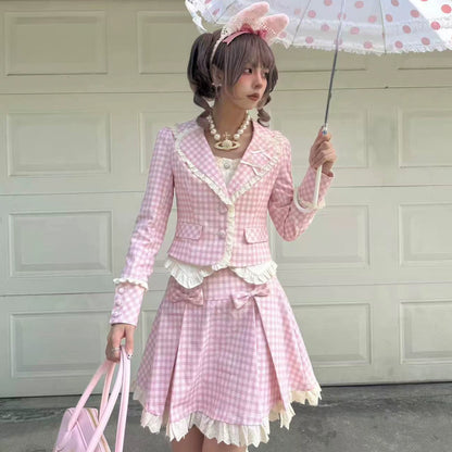 Person wearing a pink checkered outfit with a polka dot umbrella in front of a garage door.