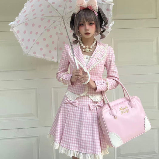 Person in a pink checkered outfit with a polka dot umbrella and matching handbag.