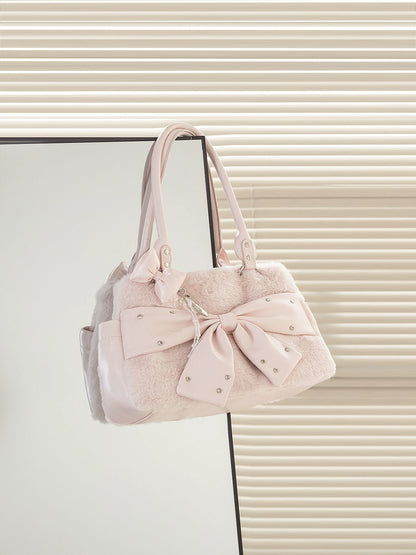 Pink handbag with a bow on a light background