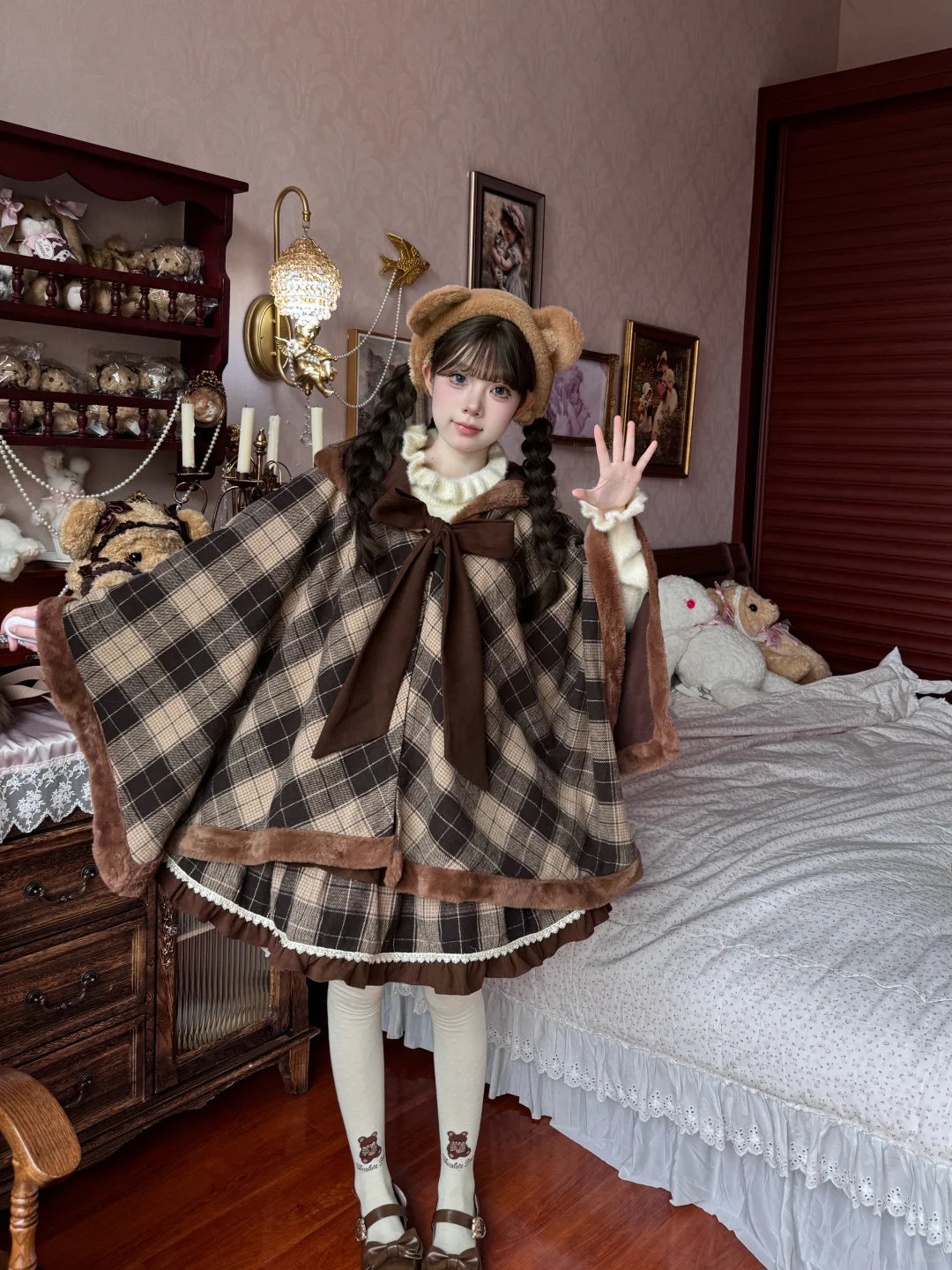 Person wearing a plaid dress with a large bow in a bedroom setting