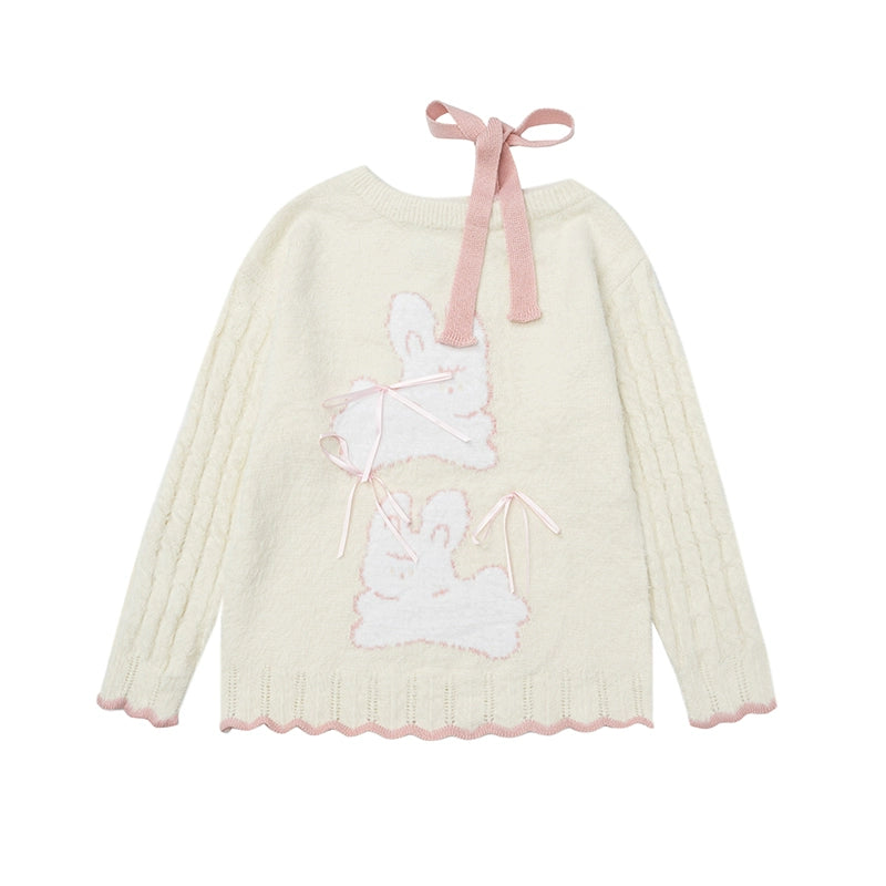 Light-colored sweater with bunny design and pink ribbon on a white background