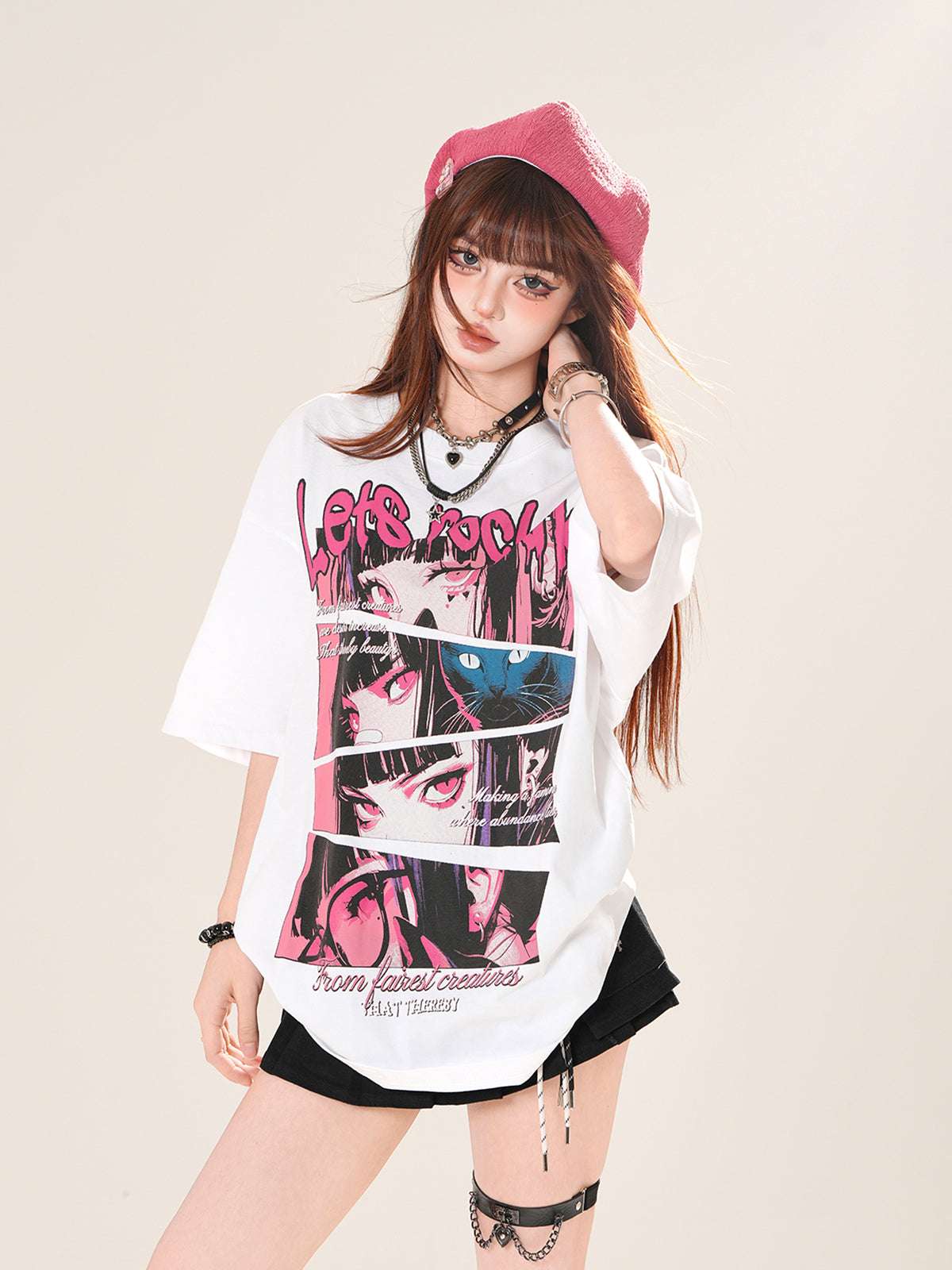 Woman wearing a graphic t-shirt with anime design and a pink cap on a beige background