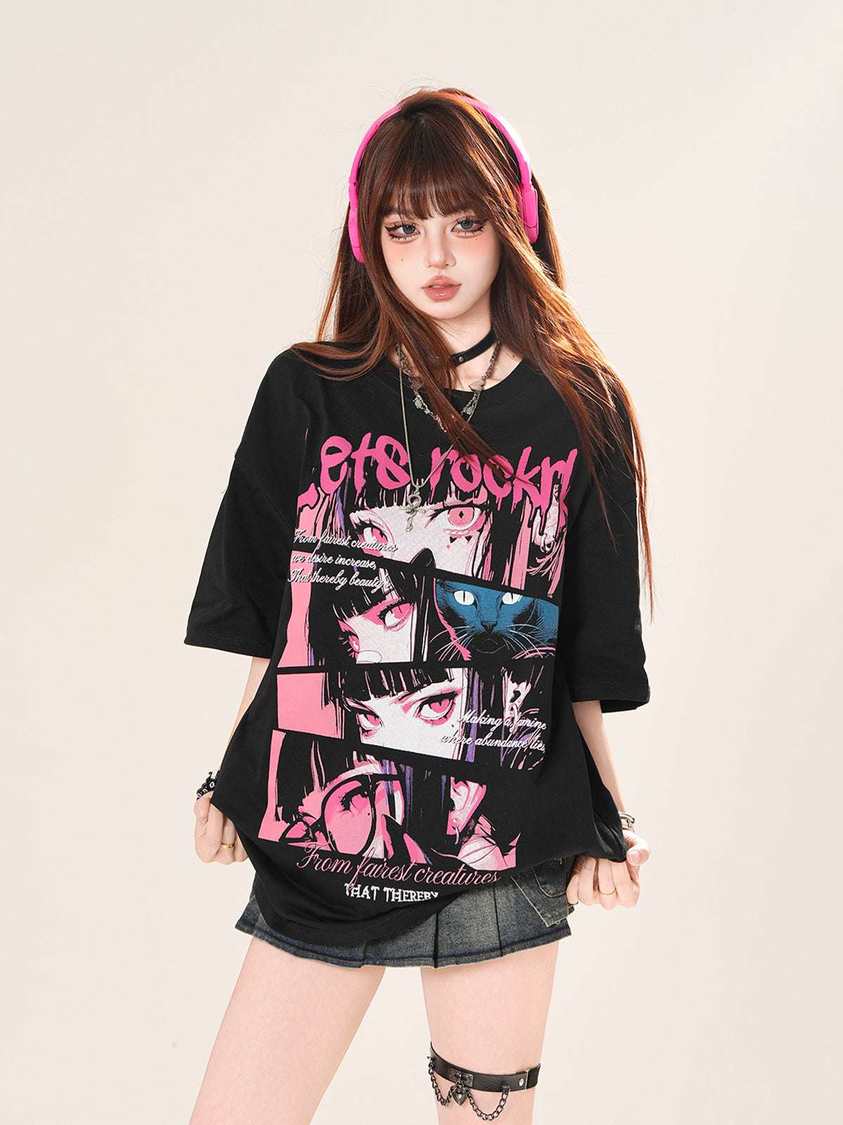 Person wearing a black t-shirt with graphic designs and pink text on a beige background