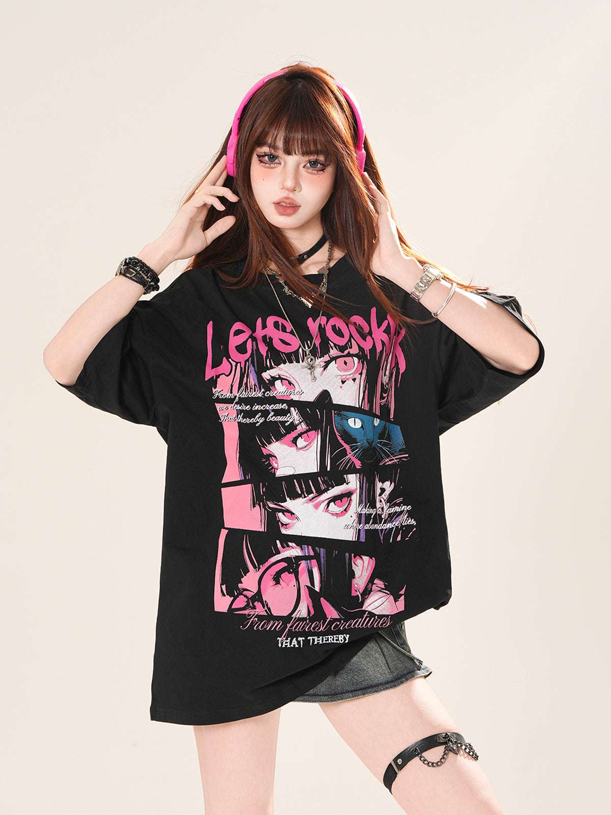 Person wearing a black oversized t-shirt with graphic designs and text.