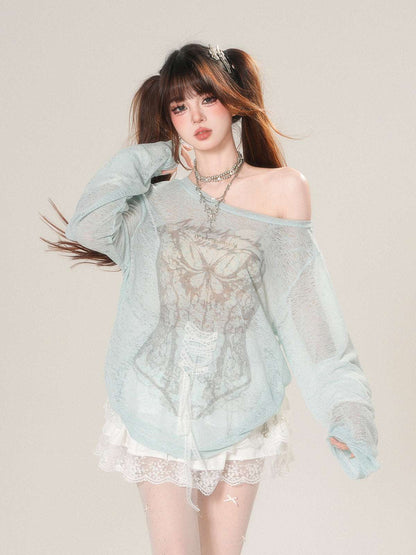 Woman wearing a light blue off-shoulder top with lace details on a plain background