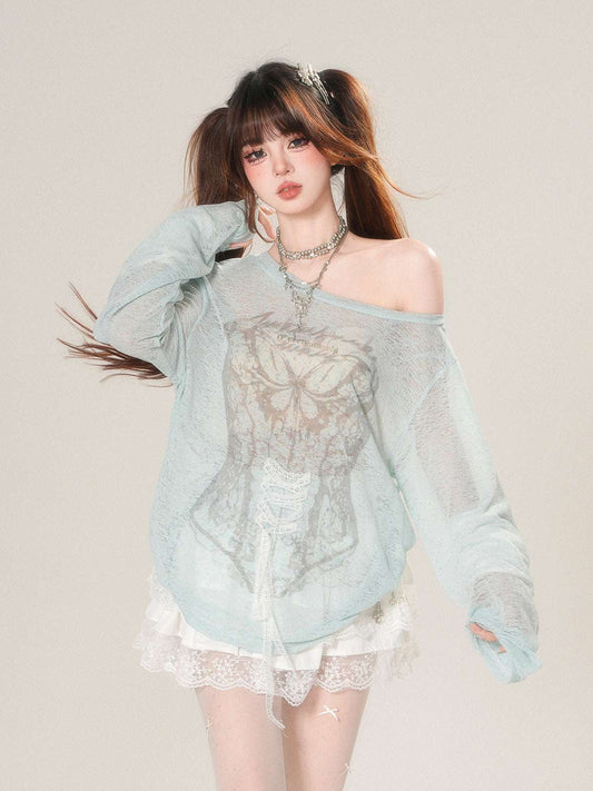 Woman wearing a light blue off-shoulder top with lace details on a plain background