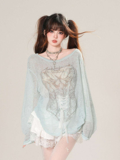 Woman wearing a light blue sheer top with lace details on a plain background