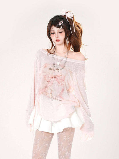 Woman wearing a sheer top with a pink bow design on a white background