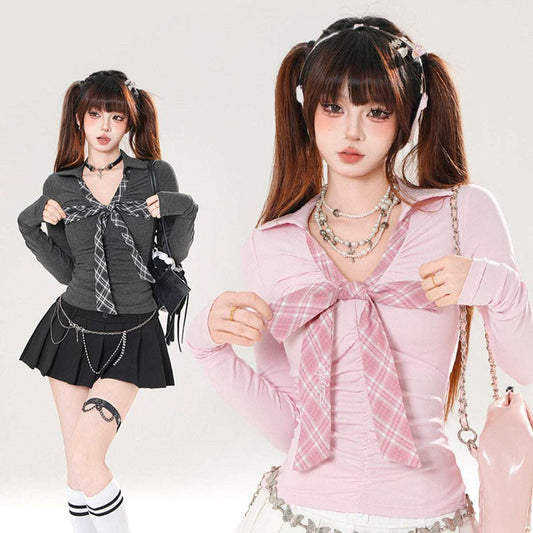 Two women wearing plaid shirts with bows, one in gray and black outfit, the other in pink and white.