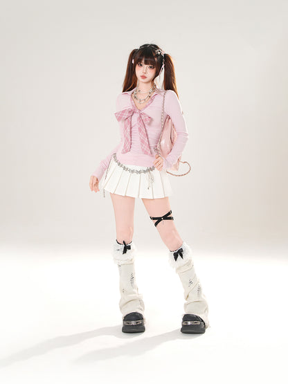 Person wearing a pink top with a bow, white skirt, and high socks with black shoes on a white background