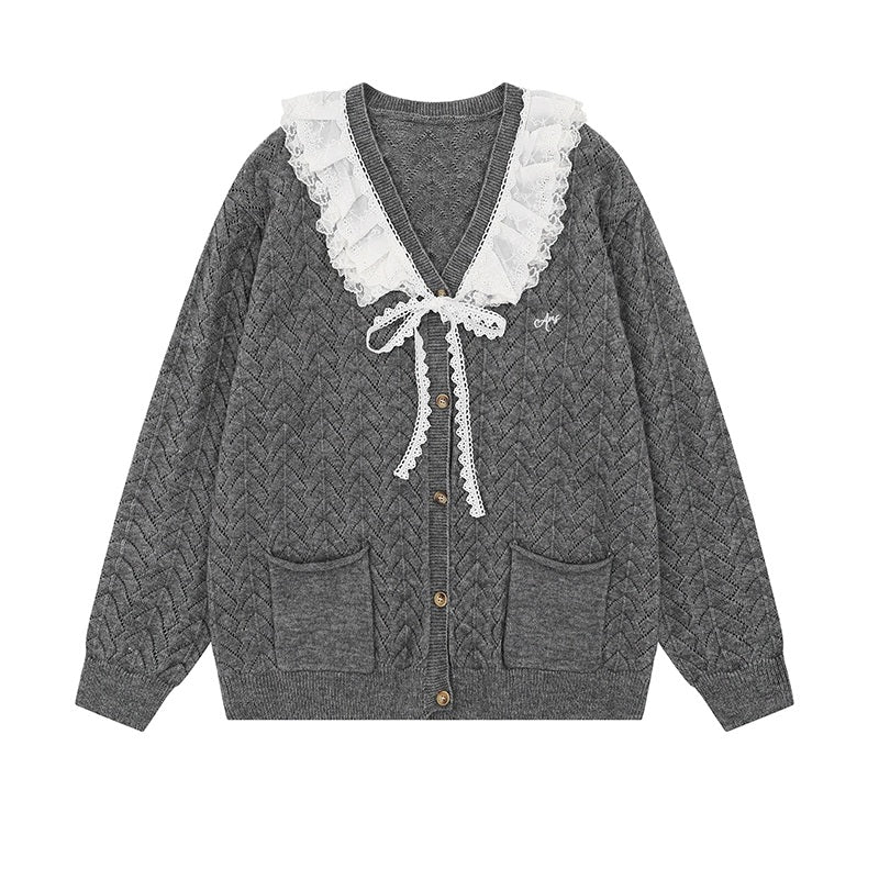 Gray cable knit cardigan with white lace trim on a white background