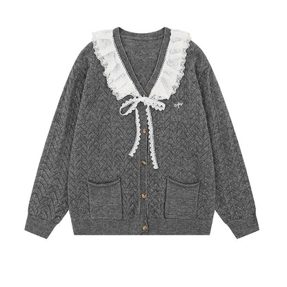 Gray cable knit cardigan with white lace trim on a white background