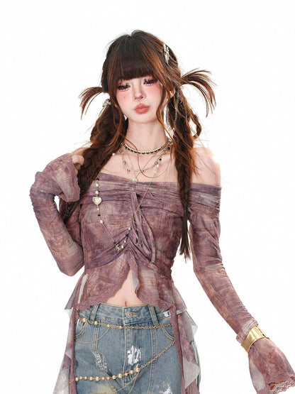 Person wearing a stylish outfit with a sheer top and denim skirt on a white background