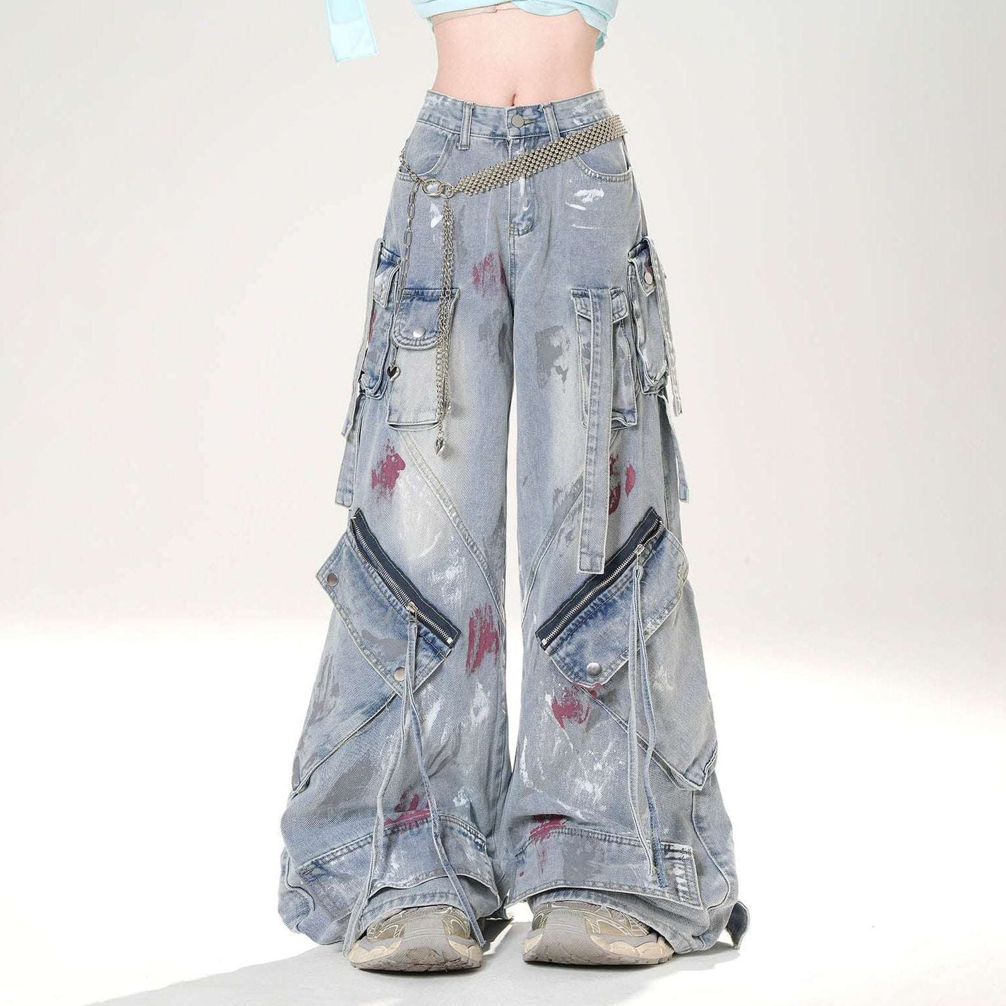 Distressed denim wide-leg pants with zippers on a white background